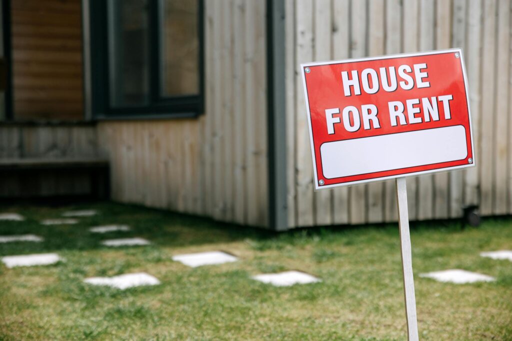 red and white signage near the wooden house