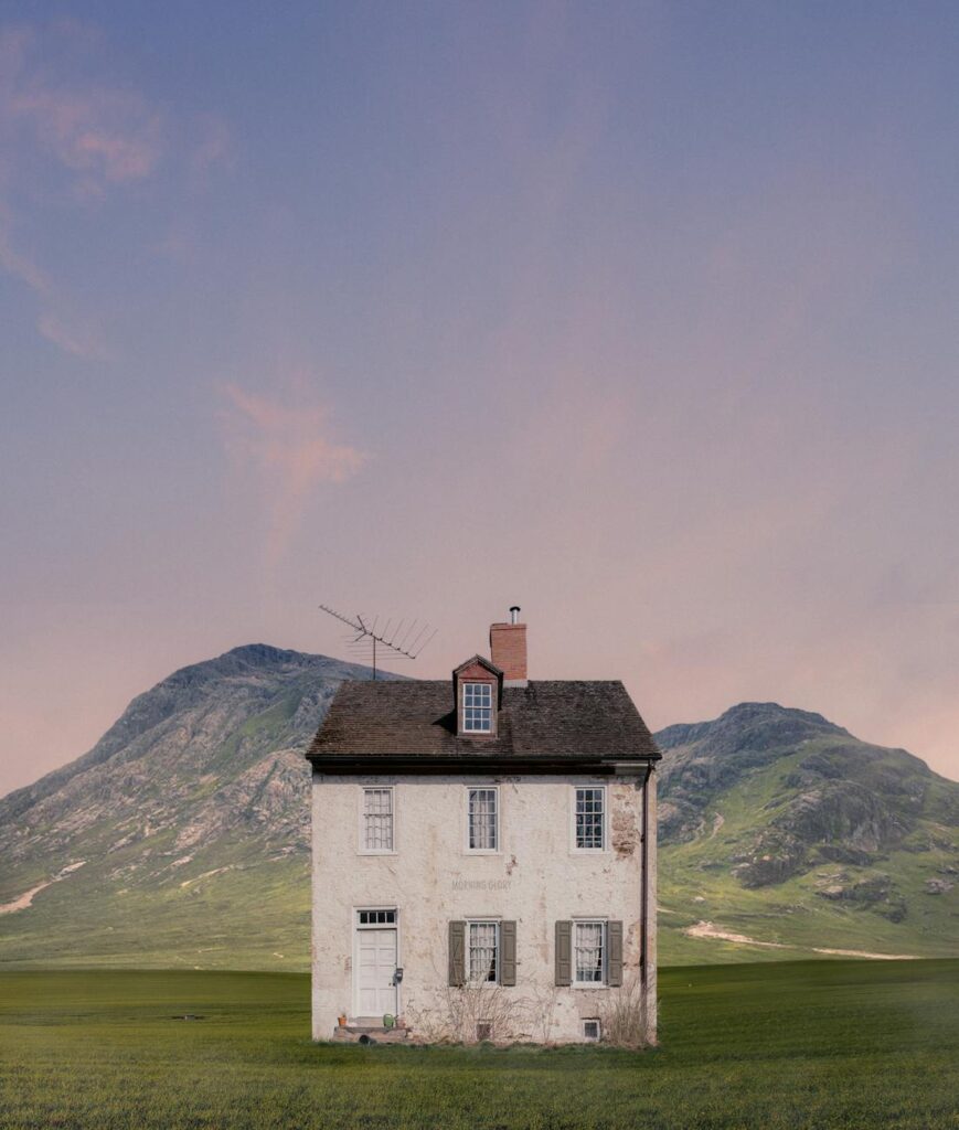 an abandoned concrete house near the green mountains